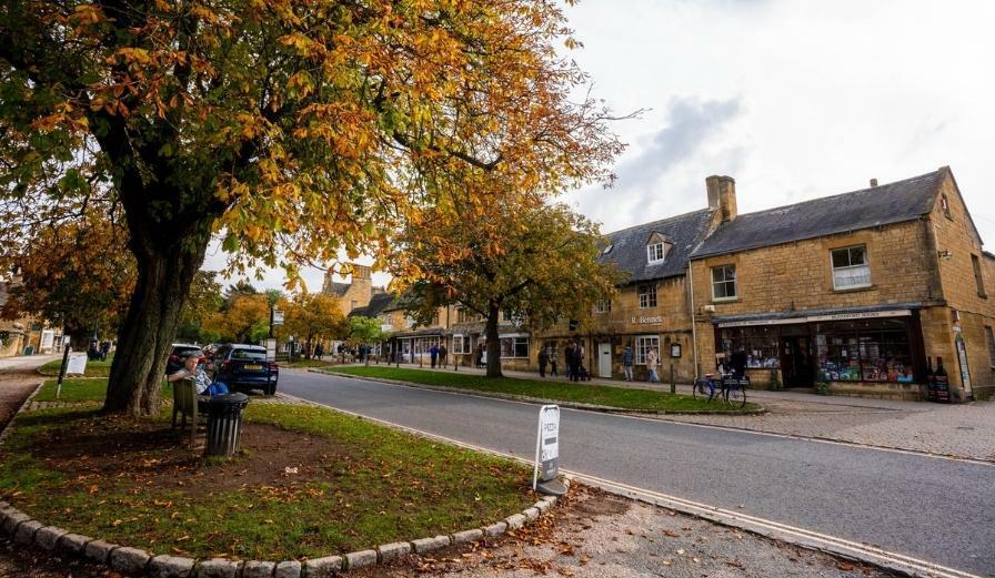 Photo of Broadway High Street with cotswold stone shops in the background