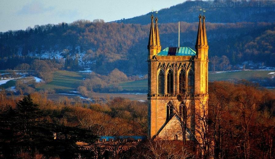 Photo of Pershore Abbey with winter countryside in the background