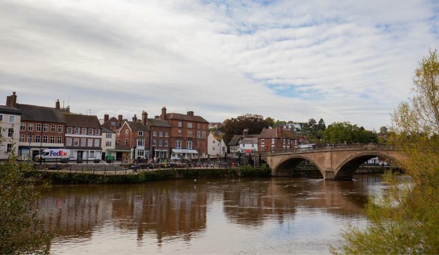 Photo of River Severn at Bewdley with bridge and shops in the distance
