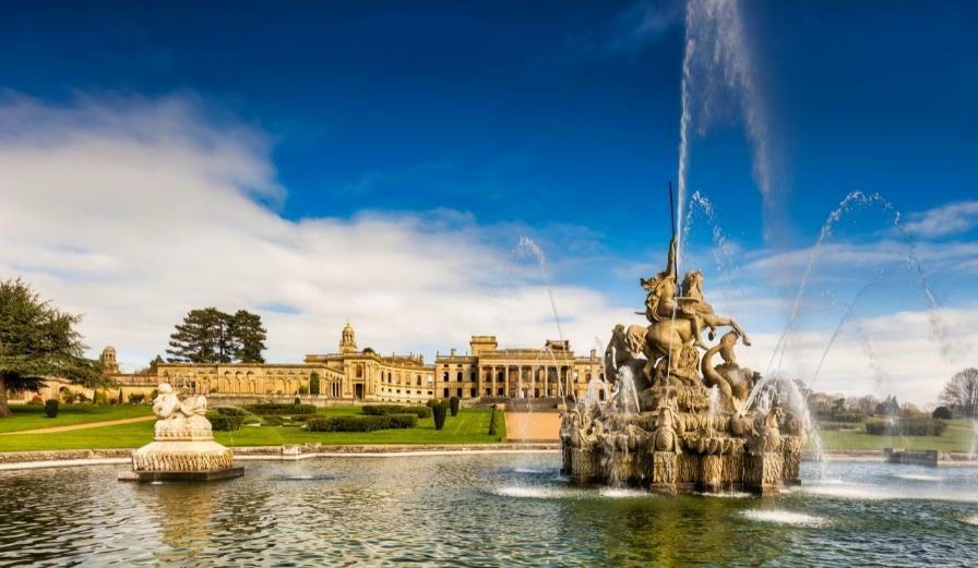 Photo of Witley Court on a bright sunny day with fountain in the foreground