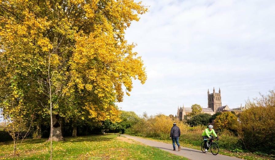 Photo of autumn scene with walkers and cyclist in foreground