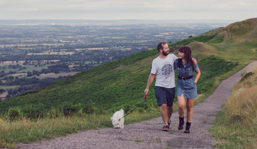 Photo of couple walking along the Malvern Hills with a dog