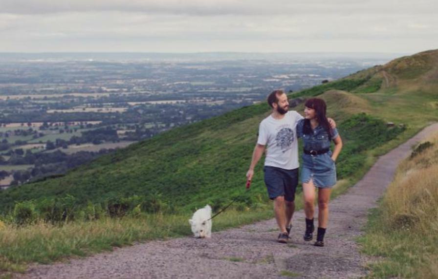 Photo of couple walking on the Malvern Hills with dog