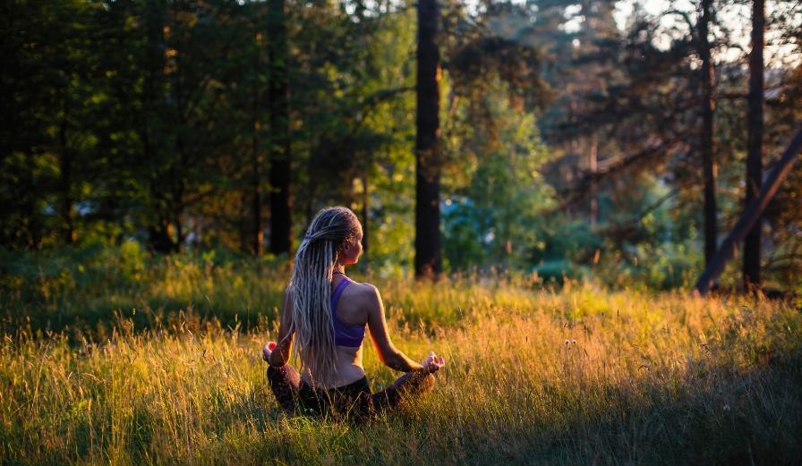 Photo of girl practicing yoga in the forest