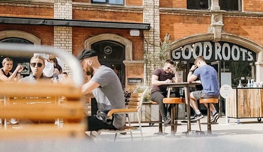 Photo of people sitting outside Good Roots in Worcester