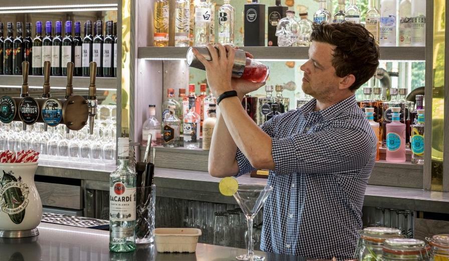 Photo of staff member making a cocktail at a bar