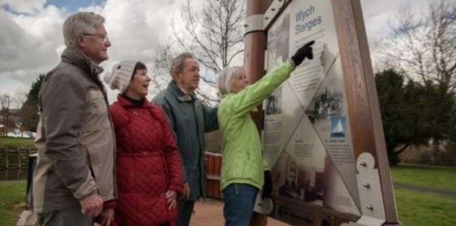 Photo of visitors reading sign near the canal