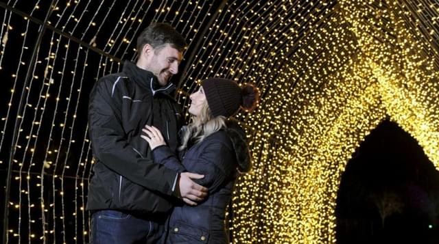 Couple standing in light tunnel at Winter Glow Malvern