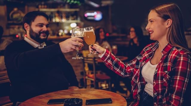 Photo of a couple toasting glasses