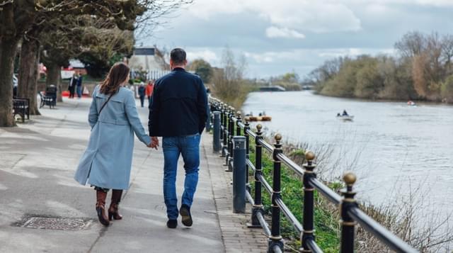 Photo of a couple walking down the River Severn
