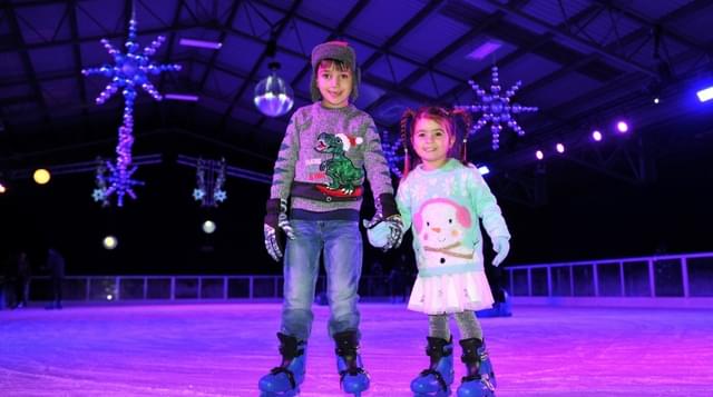 Photo of children holding hands on ice ring