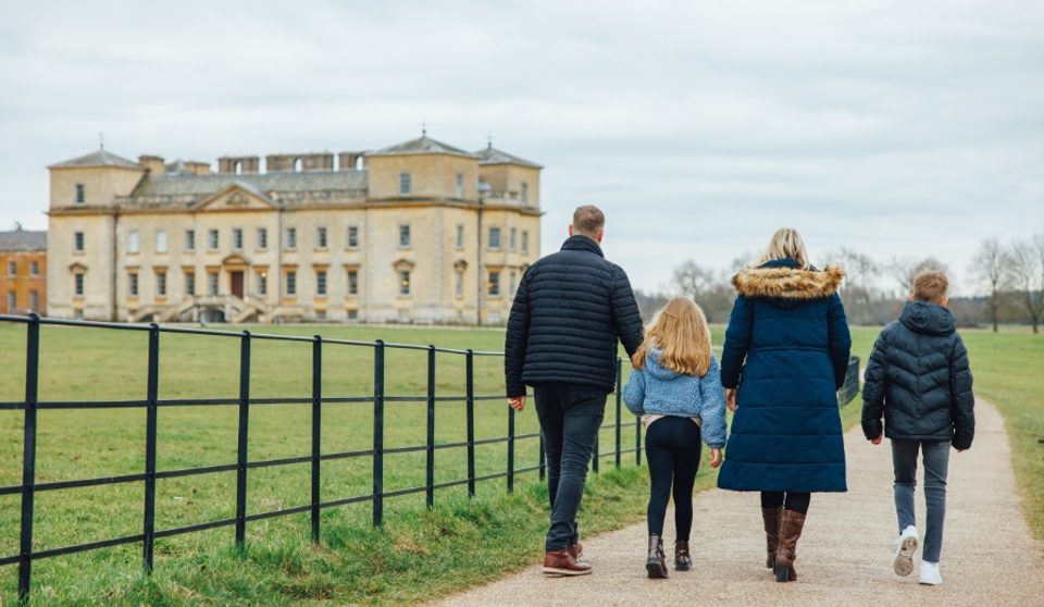 Photo of family walking towards Croome Court Holding hands