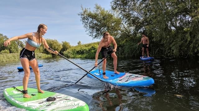 Photo of two people paddleboarding on the River Avon