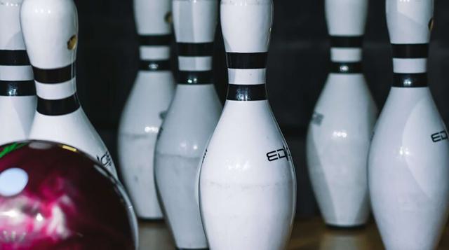 White bowling pins being knocked over at tenpin bowling 5