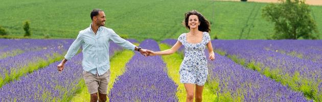 Two visitors running through lavender fields in Broadway