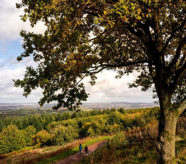 Photo of Clent hills with people walking in the foreground